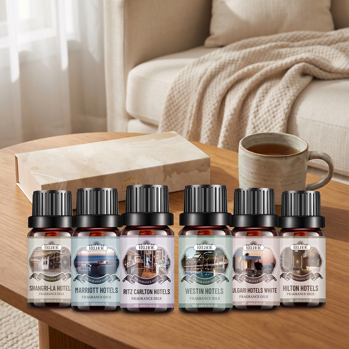 Six bottle fragrance oil set and cream gift box on a wooden coffee table next to a mug of tea