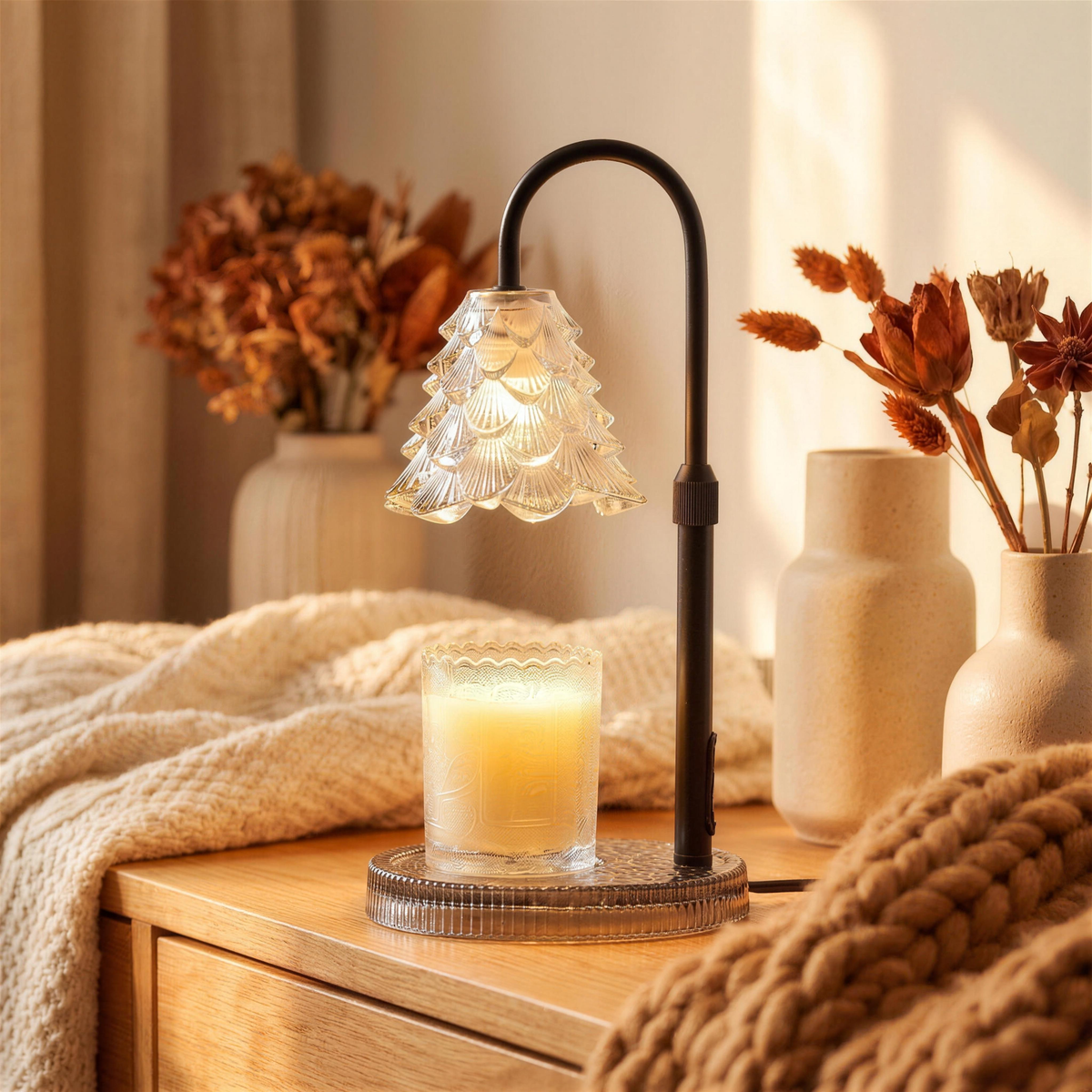 White candle warmer lamp switched on, warming a jar candle on a side table