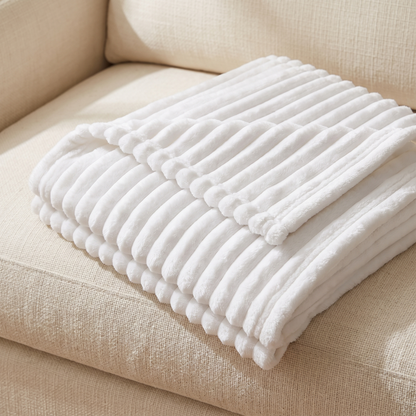 Close-up of the raised ribbed channels on the white fleece throw