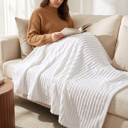 Woman reading on a sofa under the white ribbed fleece throw